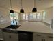 Open kitchen with island sink, stainless steel dishwasher and lots of natural light at 79 Willow Cameron Way, Angier, NC 27501