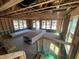 Unfinished living room featuring exposed beams, unfinished walls, and multiple windows at 79 Willow Cameron Way, Angier, NC 27501