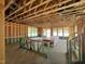 Spacious living room shows exposed beams, unfinished walls, and natural light at 79 Willow Cameron Way, Angier, NC 27501