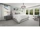 Comfortable main bedroom showcasing a large bed, decorative wall hangings, and a seating area with ample natural light at 79 Willow Cameron Way, Angier, NC 27501