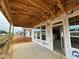 Covered patio with wooden frame and concrete base overlooking the neighborhood at 79 Willow Cameron Way, Angier, NC 27501