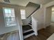 Staircase with dark wood treads and white risers and railings at 79 Willow Cameron Way, Angier, NC 27501