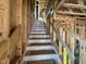 Ascending unfinished staircase with a protective plastic wrap, in a home under construction at 79 Willow Cameron Way, Angier, NC 27501