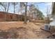 Spacious backyard with mature trees, potential for landscaping and outdoor activities at 809 S Plum St, Durham, NC 27701