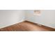 Sunlit bedroom featuring wood-look flooring, a window, and neutral walls at 809 S Plum St, Durham, NC 27701