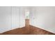 Bedroom with hardwood floors, closet, and view of the kitchen at 809 S Plum St, Durham, NC 27701
