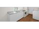 Bright kitchen features a stainless steel sink, white appliances, and ample counter space at 809 S Plum St, Durham, NC 27701