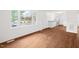 Bright living room with large window, new hardwood floors, and fresh white paint at 809 S Plum St, Durham, NC 27701
