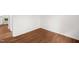 Cozy room showcasing wood-look floors and neutral walls; kitchen appliances visible at 809 S Plum St, Durham, NC 27701