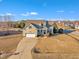 Suburban home with two-car garage, dormer windows and a long drive with an expanse of lawn under a sunny, cloudy sky at 8116 Hartwood Glen Cir, Willow Springs, NC 27592