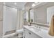 Bathroom featuring white vanity, mirror and tiled shower with curtain at 8116 Hartwood Glen Cir, Willow Springs, NC 27592