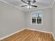 Bedroom featuring hardwood floors, ceiling fan, crown molding and natural light at 8116 Hartwood Glen Cir, Willow Springs, NC 27592