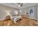 Bright bedroom with hardwood floors, ceiling fan and warm decor at 8116 Hartwood Glen Cir, Willow Springs, NC 27592