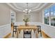 Charming dining room with hardwood floors, chandelier, and wainscoting at 8116 Hartwood Glen Cir, Willow Springs, NC 27592