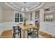 Dining room with wood floors, chandelier, and open layout to living room at 8116 Hartwood Glen Cir, Willow Springs, NC 27592