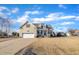 Traditional two-story home with two-car garage, dormer windows, manicured front yard and covered front porch entrance at 8116 Hartwood Glen Cir, Willow Springs, NC 27592