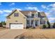 Charming home with attached garage, manicured lawn and inviting front porch at 8116 Hartwood Glen Cir, Willow Springs, NC 27592