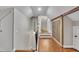 Hallway with hardwood floors, steps, and rustic barn door at 8116 Hartwood Glen Cir, Willow Springs, NC 27592