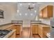 Kitchen features wood cabinets, granite countertops and stainless steel appliances at 8116 Hartwood Glen Cir, Willow Springs, NC 27592