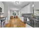 Updated kitchen features hardwood floors, stainless steel appliances, and white cabinetry at 8116 Hartwood Glen Cir, Willow Springs, NC 27592