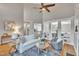 Bright living room boasts a ceiling fan, hardwood floors, and a view into other rooms with white trim and shelving at 8116 Hartwood Glen Cir, Willow Springs, NC 27592