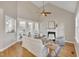 Open-concept living room with a fireplace, hardwood floors, views of other rooms and comfortable seating arrangement at 8116 Hartwood Glen Cir, Willow Springs, NC 27592