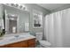 Bathroom with a window above the toilet and a combination shower and bathtub at 813 Woodside Park Ln, Durham, NC 27704