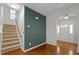 Inviting entryway featuring hardwood floors, staircase, and an arched doorway at 813 Woodside Park Ln, Durham, NC 27704