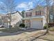 Charming two-story home with a well-manicured front yard, attached garage and red shutters at 813 Woodside Park Ln, Durham, NC 27704