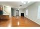 Open living area featuring hardwood floors, a fireplace, and a view to kitchen at 813 Woodside Park Ln, Durham, NC 27704