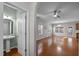 Open-concept living room featuring hardwood floors, an arched doorway and neutral paint at 813 Woodside Park Ln, Durham, NC 27704