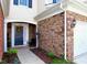 Inviting front entry with a decorative wreath, stone accents, and a cozy sitting area at 8329 Pilots View Dr, Raleigh, NC 27617