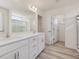 Modern primary bathroom with double vanity, walk-in closet, and linen storage at 89 Willow Cameron Way, Angier, NC 27501