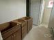 Bathroom in progress, cabinets with unfinished flooring and a white door at 89 Willow Cameron Way, Angier, NC 27501