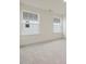 Bright, carpeted bedroom featuring two large windows and neutral walls at 89 Willow Cameron Way, Angier, NC 27501