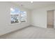 Bright bedroom with carpet floors, two large windows, and an open door to a walk-in closet at 89 Willow Cameron Way, Angier, NC 27501