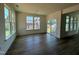 Bright dining room with hardwood floors, multiple windows, and access to a sliding door to a patio at 89 Willow Cameron Way, Angier, NC 27501