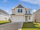 Attractive two-story home with a two-car garage, neutral siding, and a well-maintained front lawn at 89 Willow Cameron Way, Angier, NC 27501