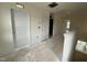 Upstairs hallway in a new home with unfinished flooring and multiple doors at 89 Willow Cameron Way, Angier, NC 27501