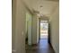 Inviting hallway with wood flooring, neutral walls, and ample natural light streaming in through the front door at 89 Willow Cameron Way, Angier, NC 27501