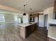 Modern kitchen featuring an island with a sink, stainless steel appliances, and plenty of cabinet space at 89 Willow Cameron Way, Angier, NC 27501