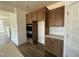 Kitchen features wooden cabinets, stainless steel appliances, and white tile backsplash with ample counter space at 89 Willow Cameron Way, Angier, NC 27501
