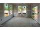 Unfinished room with drywall, large windows, and a sliding glass door allowing ample sunlight at 89 Willow Cameron Way, Angier, NC 27501