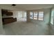 Spacious living room with large windows, neutral walls, and unfinished concrete flooring throughout space at 89 Willow Cameron Way, Angier, NC 27501