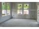 A spacious living room featuring large windows and prepped for drywall at 89 Willow Cameron Way, Angier, NC 27501