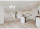 Open-concept living room and kitchen with stainless appliances and bright countertops at 89 Willow Cameron Way, Angier, NC 27501