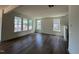 Spacious living room featuring hardwood floors, multiple windows, and neutral paint colors that brighten the space at 89 Willow Cameron Way, Angier, NC 27501