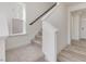 Carpeted staircase featuring natural light, access to the second floor, and open concept living at 89 Willow Cameron Way, Angier, NC 27501