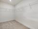 Spacious walk-in closet featuring carpeted floor and wire shelving to maximize storage potential at 89 Willow Cameron Way, Angier, NC 27501