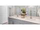 Bathroom featuring a double sink vanity with modern faucets, white countertop, and a glass-enclosed shower at 904 Canis Minor Rd, Wendell, NC 27591